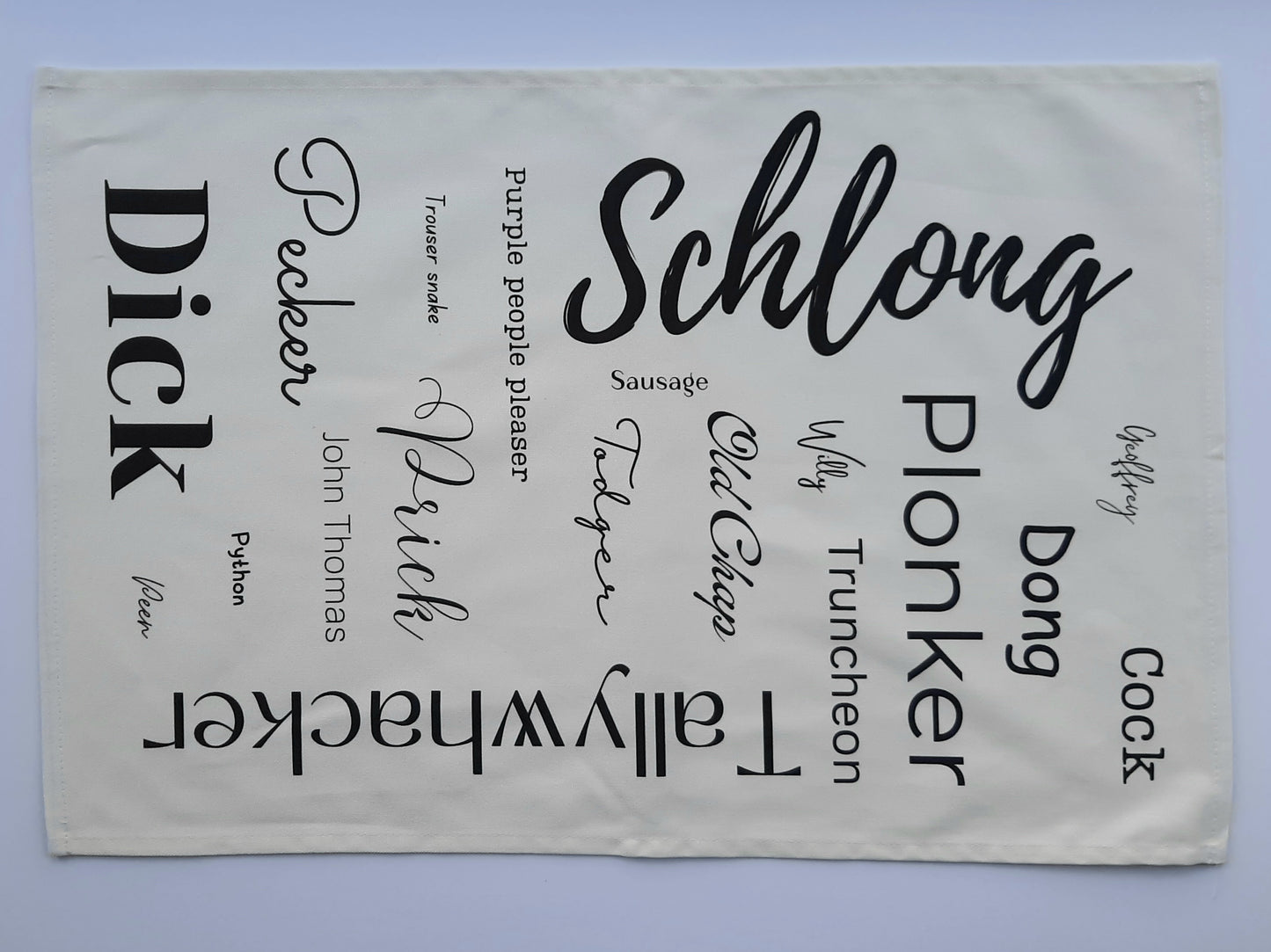 A tea towel featuring synonyms for penis in a variety of fonts